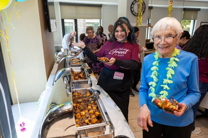 Guests enjoying a Hawaiian celebration at Belmont Village