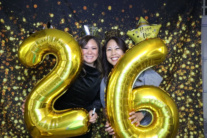 Two guests celebrating 2026 at a 4kphotoz New Year's photo booth