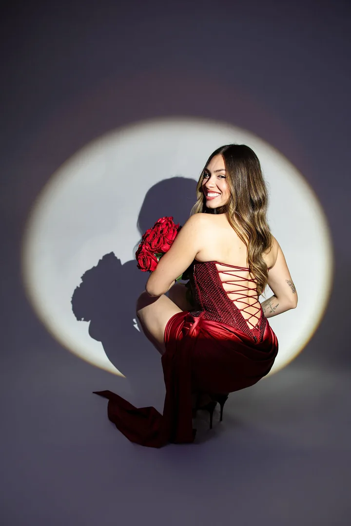 Studio portrait in a red dress with a dramatic circular spotlight